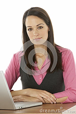 Female Businesswoman Using Laptop At Desk Stock Photo