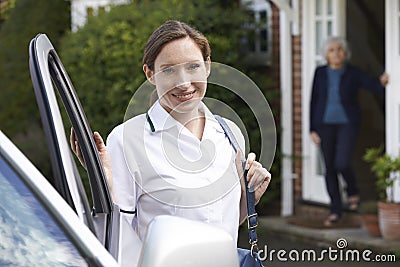 Female Care Worker Visiting Senior Woman At Home Stock Photo