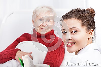 Female caregiver reading book Stock Photo
