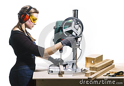 Female carpenter and drilling machine. Stock Photo