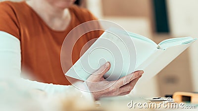 Female carpenter reading DIY project instruction manual Stock Photo