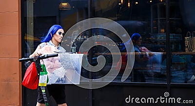 Female character with blue hair on the street in speed. Editorial Stock Photo