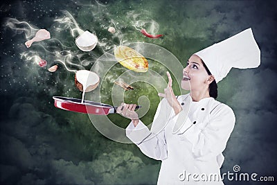 Female chef cooking with magic Stock Photo