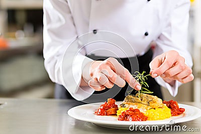 Female Chef in restaurant kitchen cooking Stock Photo