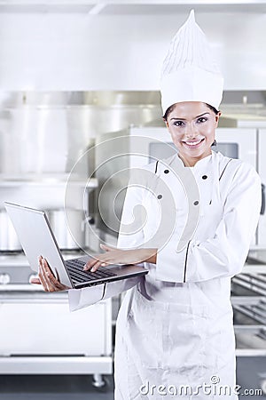 Female Chef Using Laptop Stock Photo