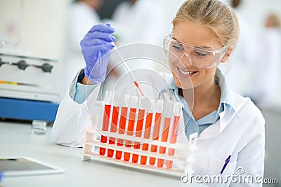 Female chemical assistant doing experiment in chemical laborator Stock Photo