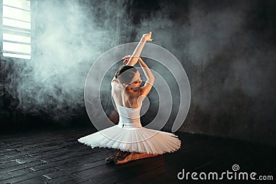 Female classical ballet performer sitting on floor Stock Photo