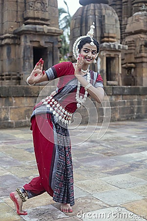 Female classical Odissi Dancer wears traditional costume with hand mudra at Mukteshvara Temple, Odisha, India Stock Photo