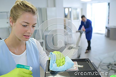 Female cleaner cleaning corridor business building Stock Photo