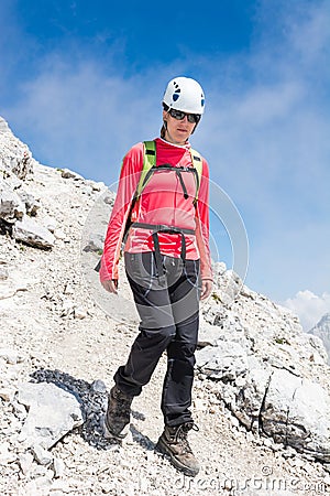 Female climber descending a mountain trail Stock Photo