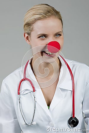 Female clown doctor with red nose Stock Photo