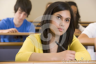 Female college student listening to a lecture Stock Photo