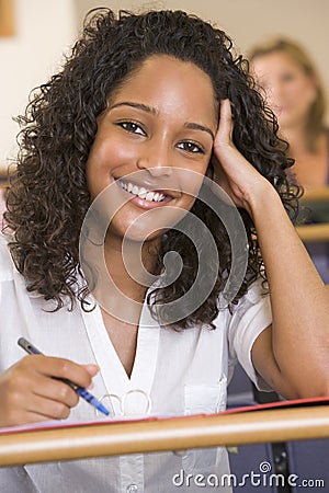 Female college student listening to a lecture Stock Photo