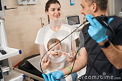 Female communicating with friendly endoscopist before endoscopy of her child Stock Photo