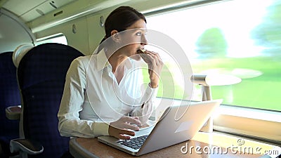 Female Commuter On Train Using Laptop Whilst Eating Sandwich stock footage Female Commuter On Train Using Laptop Whilst Eating Sandwich stock footage
