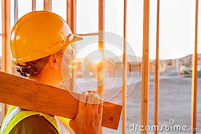 Female Construcion Worker Looking Out From New Home Framing Stock Photo