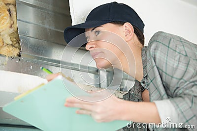 female contractor on site holding clipboard Stock Photo