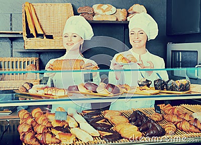 Female cooks demonstrating and selling pastry in the cafe Stock Photo