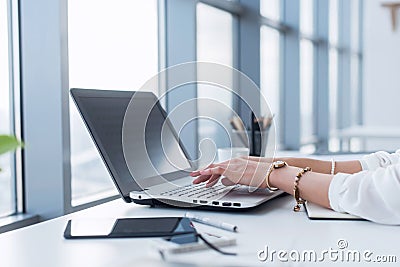 Female copywriter at her workplace, home, writing new text using laptop and Wi-Fi internet connection in the morning. Stock Photo
