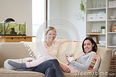 Female couple having tea at home Stock Photo