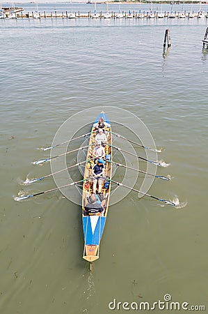 Female crew is training on a rowing boat in venice canal. Editorial Stock Photo