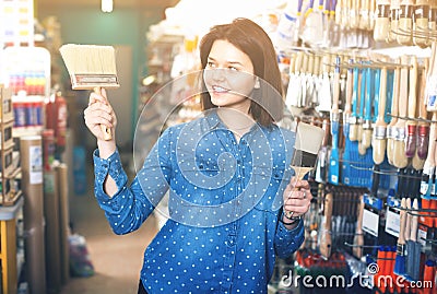 Female customer examining various painting brushes Stock Photo