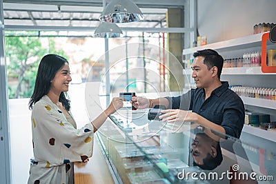 female customer paying the stuff using the credit card Stock Photo