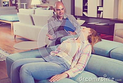 Female customer is testing new furniture Stock Photo