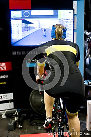 Female cyclist training indoor Stock Photo