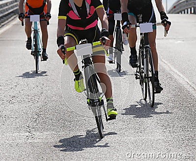 Female cyclist and other cyclists with fast race bike Stock Photo