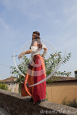 Female dancer in medieval costume dancing and swinging white ribbons Editorial Stock Photo