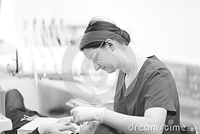 A female dentist examines the oral cavity of a patient Stock Photo