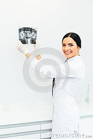 Female Dentist Looking at Dental Xray in Clinic Stock Photo