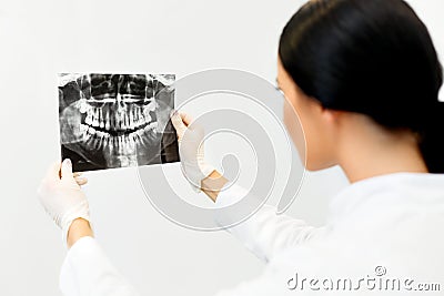 Female Dentist Looking at Dental Xray in Clinic Stock Photo