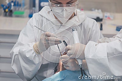 Female dentist with a patient in her office. Patient with open mouth and woman dentist working. dental health concept Stock Photo