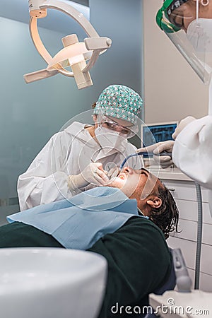 Female dentist with a patient in her office. Patient with open mouth and woman dentist working. dental health concept Stock Photo