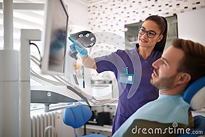 Dentist showing problematic tooth on x-ray footage Stock Photo