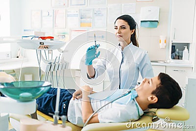 Female dentist with syringe, pediatric dentistry Stock Photo