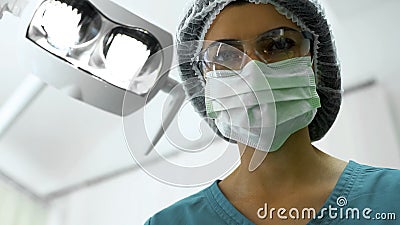 Female dentist waiting for dental anesthesia effect, preparation for surgery Stock Photo