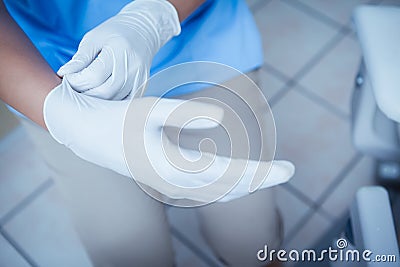 Female dentist wearing surgical glove Stock Photo