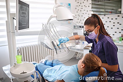 Female dentist working in dental clinic with patient Stock Photo