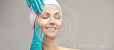 Female derma rejuvenate treatment. Doctor in gloves touch woman face. Cosmetology pretty portrait. Facial injection patient Stock Photo