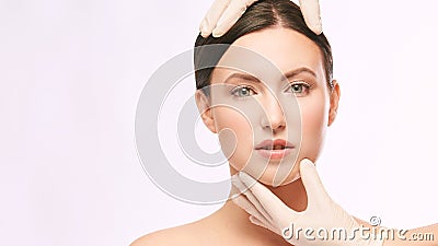 Female derma rejuvenate treatment. Doctor in gloves touch woman face. Cosmetology pretty portrait. Facial injection patient Stock Photo