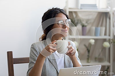 Female designer drinking coffee satisfied with self realization in profession Stock Photo