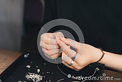 Female designer making jewelries at a jewelry shop o Stock Photo