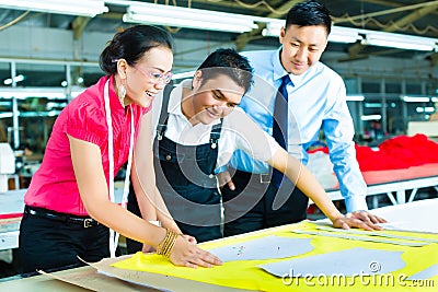 Worker, Dressmaker and CEO in a factory Stock Photo