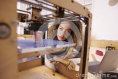 Female Designer Working With 3D Printer In Design Studio Stock Photo