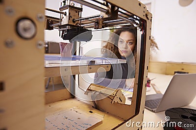 Female Designer Working With 3D Printer In Design Studio Stock Photo