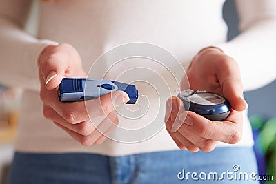 Female Diabetic Checking Blood Sugar Levels Stock Photo