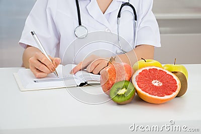 Female dietician writing prescription Stock Photo